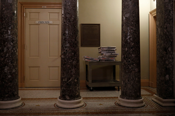 Pizza boxes are seen outside the offices of Senate Majority Leader Mitch McConnell as legislators work into the night to avert a government shutdown at the U.S. Capitol January 19, 2018 in Washington, DC. A continuing resolution to fund the government has passed the House of Representatives but faces a stiff challenge in the Senate. US Government Shutdown,US Shutdown,Senate debates,Donald Trump,US President Donald Trump,US government,US Shutdown pics,US Shutdown images,US Shutdown stills,US Shutdown pictures,US Shutdown photos