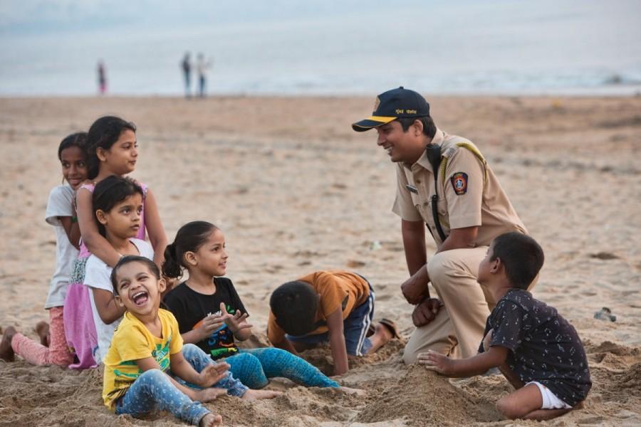 Policeman with kids on the beach. Let them build the castles of their dreams and ambitions. We will always be there to protect them Amitabh Bachchan,actor Amitabh Bachchan,Mumbai Police 2018 Calendar,Mumbai Police Calendar,Amitabh Bachchan unveils Calendar,Mumbai Police