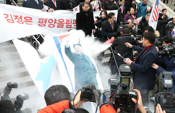 North Korea on Tuesday criticized the burning of its national flag and photos of its leader Kim Jong-un during a protest rally against its planned participation in the upcoming Winter Olympic Games in South Korea. In an article published by the Korean Central News Agency (KCNA), Pyongyang accused South Korean conservatives of unscrupulously "letting out reckless remarks chilling the hardly-won atmosphere of improved inter-Korean relations". South Korea,South Korea burns Kim Jong-un,South Korea burns Kim Jong-un photo,South Korea burns North's flag,Pyongyang,Winter Olympic Games