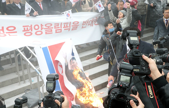 Tension between North and South Korea -- which have technically remained at war for more than 65 years -- have escalated over the last two years owing to repeated weapons tests by North Korea. South Korea,South Korea burns Kim Jong-un,South Korea burns Kim Jong-un photo,South Korea burns North's flag,Pyongyang,Winter Olympic Games