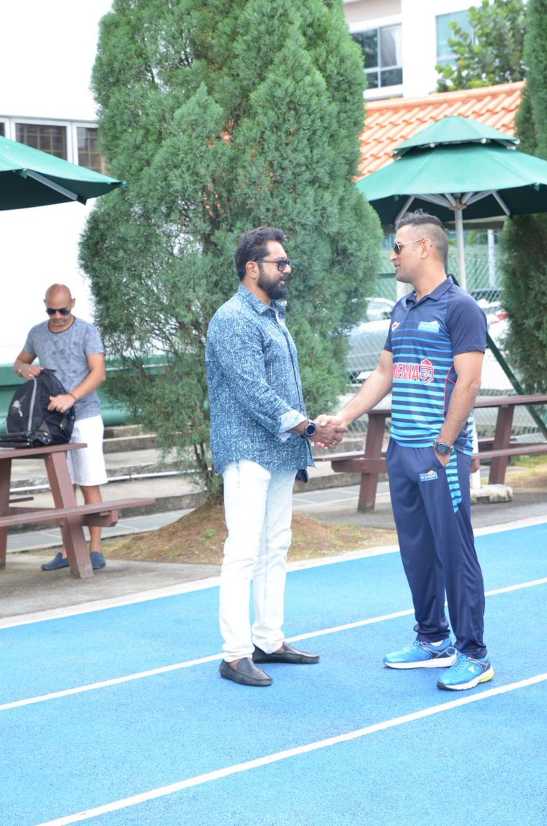 Sarathkumar and MS Dhoni greet each other during cricket academy inauguration in Singapore. Sarath Kumar,R Sarath Kumar,MS Dhoni,Dhoni,Mahendra Singh Dhoni,MS Dhoni cricket academy