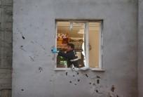 Police forensic experts examine a building which was damaged after a rocket fired from Syria landed nearby, in the border town of Kilis, Turkey January 22, 2018.