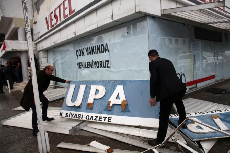 Men hold up the sign of Turkish Cypriot newspaper Afrika, which was attacked by supporters of Turkish President Tayyip Erdogan on Monday over the newspaper’s headlines criticising the Turkish army’s campaign in Afrin in northern Syria, in the Turkish-administered northern part of Nicosia, Cyprus January 22, 2018. Turkish,Turkish forces,Syria