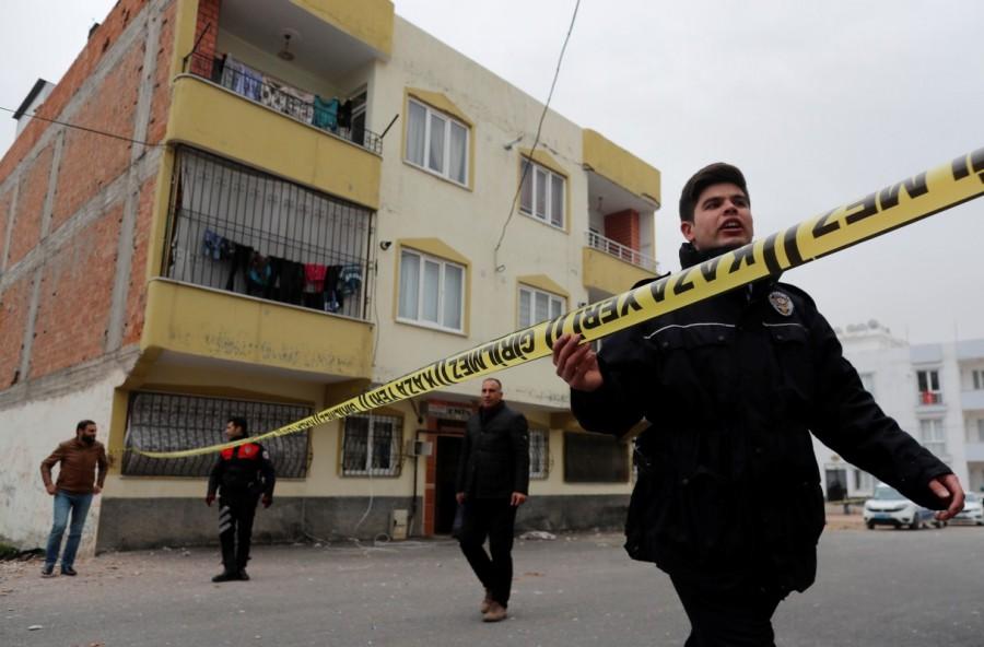 A Turkish police officer secures the area after a building was hit by a rocket fired from Syria, in the border town of Kilis, Turkey January 22, 2018. Turkish,Turkish forces,Syria