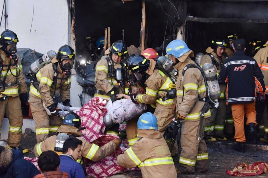 Firefighters rescue a patient from a burnt hospital in Miryang, South Korea. South Korea hospital fire,Deadly hospital fire,hospital fire in South Korea,South Korea,Miryang