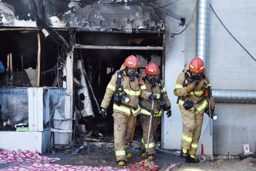 Firefighters walks out of a burnt hospital in Miryang. South Korea hospital fire,Deadly hospital fire,hospital fire in South Korea,South Korea,Miryang