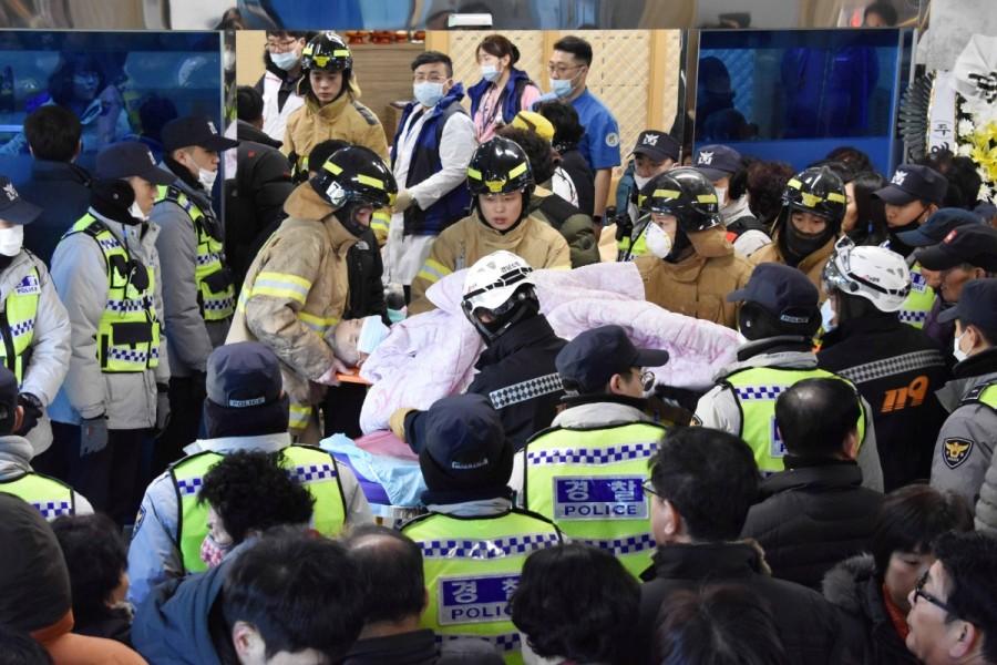 Firefighters rescue a patient from a burnt hospital in Miryang. South Korea hospital fire,Deadly hospital fire,hospital fire in South Korea,South Korea,Miryang