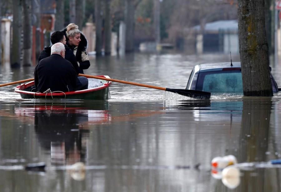 Residents on a small boat leave home in a flooded street of Villeneuve-Saint-Georges, Paris. Paris under water,Paris flooded,Seine bursts,Paris flooded after heavy rain,Paris heavy rain,heavy rain in Paris