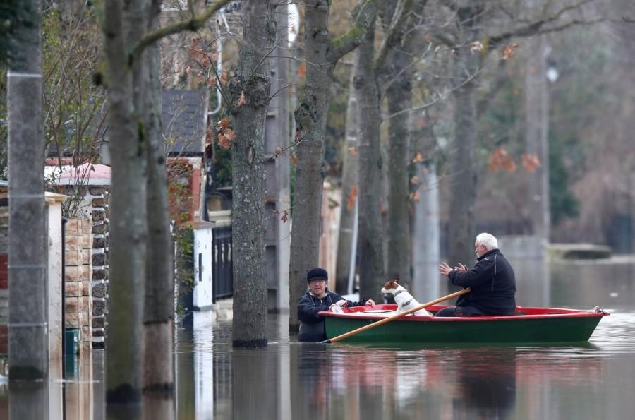 Residents on a small boat leave home in a flooded street of Villeneuve-Saint-Georges, near Paris. Paris under water,Paris flooded,Seine bursts,Paris flooded after heavy rain,Paris heavy rain,heavy rain in Paris