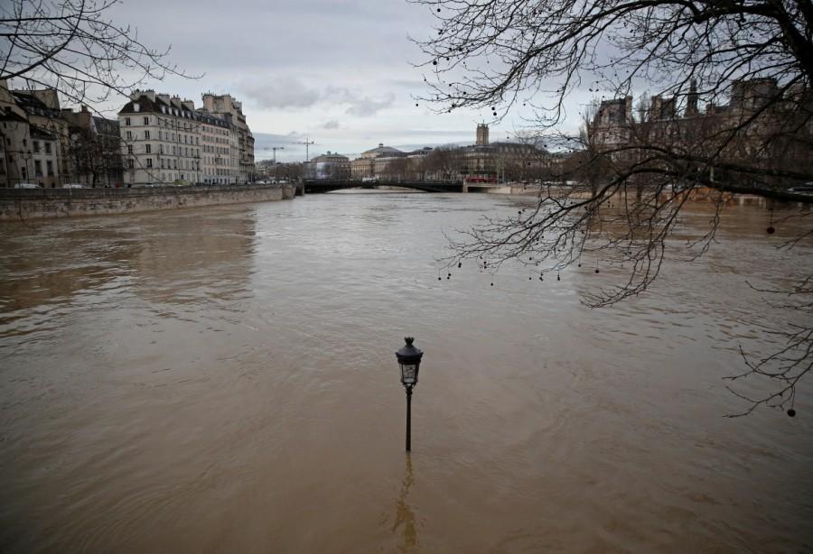 A street-lamp is seen on the flooded banks of the Seine River in Paris after days of almost non-stop rain caused flooding in France. Paris under water,Paris flooded,Seine bursts,Paris flooded after heavy rain,Paris heavy rain,heavy rain in Paris
