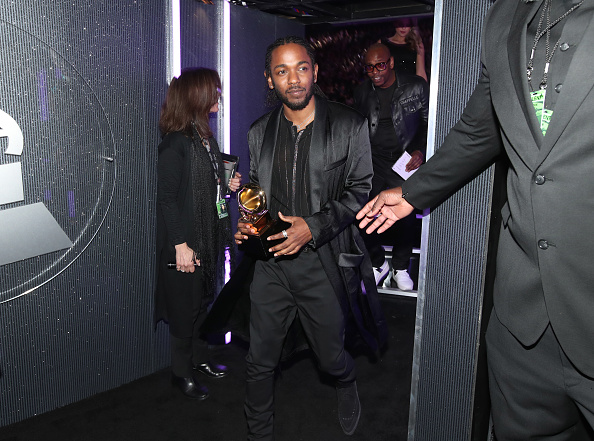 He then performed "DNA" with the 'soldiers' matching steps to the beats. The fiery performance ended with dancers in red hoodies falling amid the sound of gunshots, as Lamar rapped lyrics, and a ball of fire burst. Kendrick Lamar,singer Kendrick Lamar,Kendrick Lamar at Grammy,Grammy,Grammy Awards,60th Grammy Awards