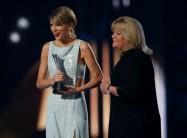 Taylor Swift accepts the Milestone Award from her mother Andrea at the 50th Annual Academy of Country Music Awards