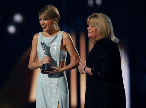 Taylor Swift accepts the Milestone Award from her mother Andrea at the 50th Annual Academy of Country Music Awards