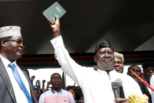 Kenyan opposition leader Raila Odinga of the National Super Alliance (NASA) holds a Bible as he takes a symbolic presidential oath of office in Nairobi, Kenya January 30, 2018. Kenyan authorities suspended television and radio stations as supporters of Odinga watched him take a symbolic presidential oath in a Nairobi park in a direct challenge to President Uhuru Kenyatta.