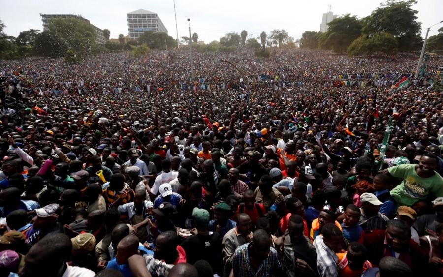 Supporters of Raila Odinga gather during his swearing-in ceremony. During a speech lasting less than five minutes, Odinga declined to give details of his plans and said they would be disclosed in "due course." In a possible sign of division within the opposition alliance, Odinga's vice presidential candidate and two other senior leaders were absent. Odinga said the vice president would be sworn in at a later date. Raila Odinga,Kenya opposition leader,President Uhuru Kenyatta,Uhuru Kenyatta