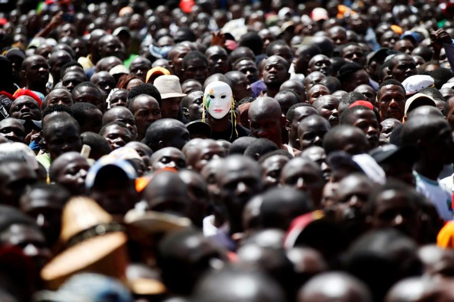 A man wears a mask among fellow supporters. Many of those at the rally had come from the capital's slums. Odinga has strong support there and in the west and along the coast, areas where people have long felt ignored by central government and shut out of political patronage networks. Raila Odinga,Kenya opposition leader,President Uhuru Kenyatta,Uhuru Kenyatta