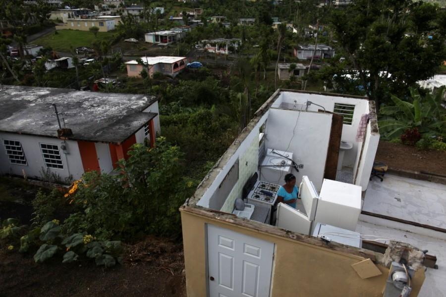 Ernestina Lebron looks at her refrigerator while standing in her home, after Hurricane Maria hit the island in September 2017, in Maunabo, Puerto Rico January 27, 2018. Hurricane Maria,Hurricane Maria Puerto Rico,Puerto Rico struggles,Puerto Rico,Puerto Rico electricity,Puerto Rico Hurricane Maria irma,Puerto Rico food and water