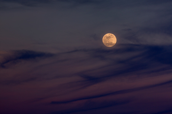 The Moon rises over the Mojave Desert before becoming a so-called 'super blue blood moon' when it becomes totally eclipsed before dawn, on January 30, 2018 near Amboy, California. The 'super blue blood moon' is a rare 'lunar trifecta' event in which the Moon is at its closest to the Earth, appearing about 14 percent brighter than usual, and is simultaneously a 'blue moon', the second full moon in the same month, as well as a total lunar eclipse or 'blood moon'. Such a lunar event that hasn't been seen since 1866. Super Blue Blood Moon,rare Super Blue Blood Moon,Eclipse 2018,Eclipse,Moon Eclipse,Super Blue Blood Moon pics,Super Blue Blood Moon images,Super Blue Blood Moon stills,Super Blue Blood Moon pictures,Super Blue Blood Moon photos,blood moon