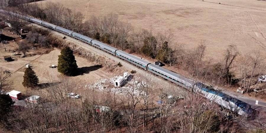 The wreckage of a garbage truck lies beside an Amtrak passenger train. Amtrak passenger train,Amtrak train,Virginia,Virginia road crossing,garbage truck