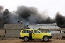 Smoke billows from a car parts store hit by shells during the conflict in the port city of Aden, Yemen January 31, 2018.