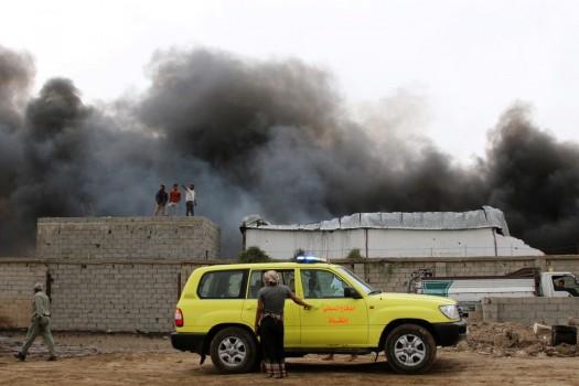 Smoke billows from a car parts store hit by shells during the conflict in the port city of Aden, Yemen January 31, 2018.