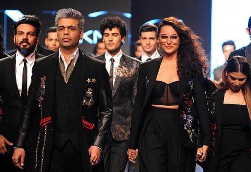 Indian Bollywood film director Karan Johar (L) and actress Sonakshi Sinha (R) showcase creations by designer Falguni Shane Peacock at the Lakmé Fashion Week (LFW) Summer Resort 2018 in Mumbai.