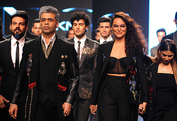 Indian Bollywood film director Karan Johar (L) and actress Sonakshi Sinha (R) showcase creations by designer Falguni Shane Peacock at the Lakmé Fashion Week (LFW) Summer Resort 2018 in Mumbai. Lakme Fashion Week 2018,lakme fashion week,Karan Johar and Sonakshi Sinha,Karan Johar,Sonakshi Sinha,Falguni and Shane Peacock