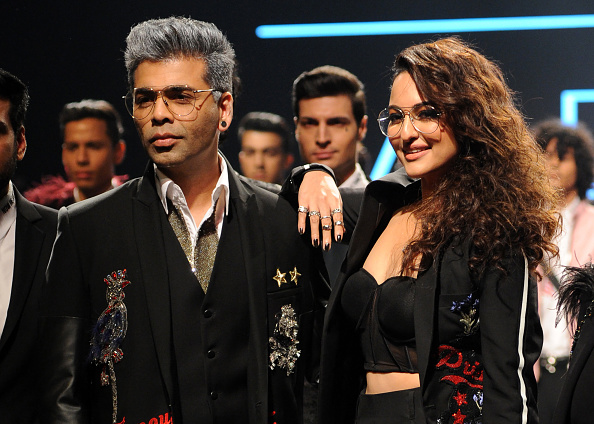 Indian Bollywood film director Karan Johar (L) and actress Sonakshi Sinha (R) showcase creations by designer Falguni Shane Peacock at the Lakmé Fashion Week (LFW) Summer Resort 2018 in Mumbai on February 2, 2018. Lakme Fashion Week 2018,lakme fashion week,Karan Johar and Sonakshi Sinha,Karan Johar,Sonakshi Sinha,Falguni and Shane Peacock