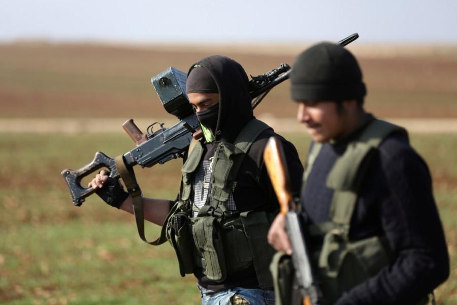 Kurdish fighters, fighting alongside the Free Syrian Army, hold weapons as they walk in northern Aleppo countryside, Syria February 1, 2018. Turkish,Turkish forces,U.S.-backed Kurdish,YPG fighters,Afrin region