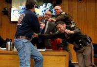 Randall Margraves (L) lunges at Larry Nassar (wearing orange), during victim statements of his sentencing in the Eaton County Circuit Court in Charlotte, Michigan. The enraged father of three daughters sexually abused by Nassar charged towards the former USA Gymnastics national team doctor and tried to attack him during a sentencing hearing in a Michigan courtroom on Friday.