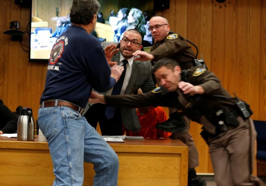 Randall Margraves (L) lunges at Larry Nassar (wearing orange), during victim statements of his sentencing in the Eaton County Circuit Court in Charlotte, Michigan. The enraged father of three daughters sexually abused by Nassar charged towards the former USA Gymnastics national team doctor and tried to attack him during a sentencing hearing in a Michigan courtroom on Friday. Larry Nassar lunges,Larry Nassar lunges father,Larry Nassar in Court