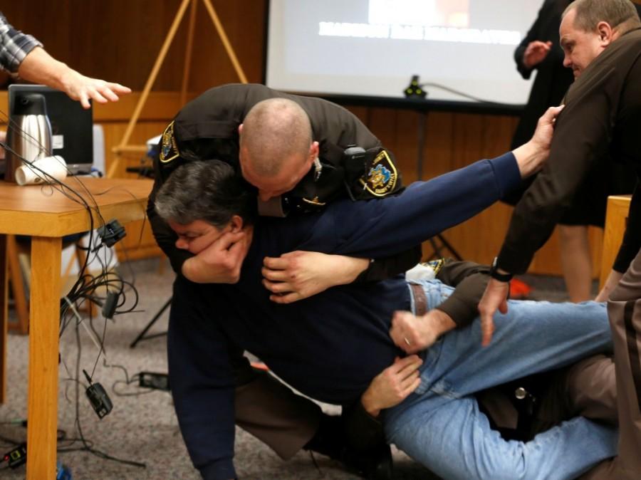 "One minute!" he demanded repeatedly, his head pinned to the floor. As court officers pulled him from the room, he implored them, "What if this happened to you guys?" Some victims fled the room in tears. Larry Nassar lunges,Larry Nassar lunges father,Larry Nassar in Court
