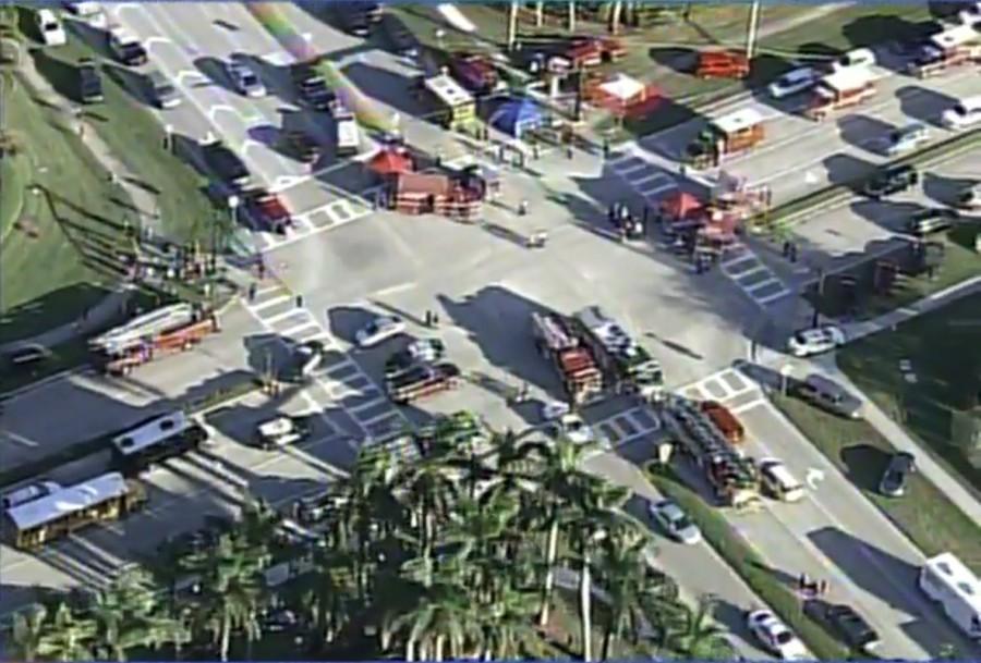 Police and rescue workers attend the scene near Marjory Stoneman Douglas High School following a shooting incident in Parkland. Mass shooting,Florida high school,Florida Mass shooting,Florida shooting
