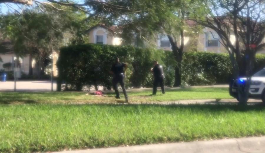 A man is placed in handcuffs by police officer, following a shooting incident in Parkland, Florida, U.S. Mass shooting,Florida high school,Florida Mass shooting,Florida shooting