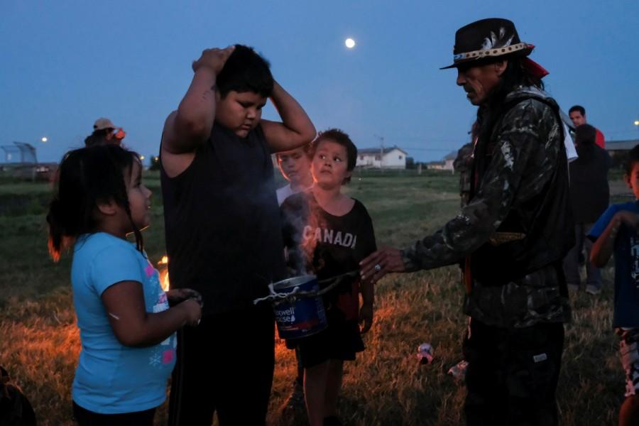 People take part in a smudging ceremony organized by the First Nations Indigenous Warriors and the American Indian Movement on the Cote First Nation, near the town of Kamsack, Saskatchewan First Nations Indigenous Warriors,Indigenous Warriors,Canada,colonial policies