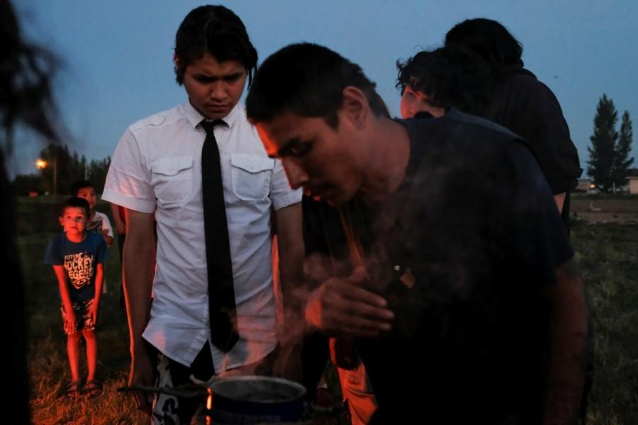 People take part in a smudging ceremony organized by the First Nations Indigenous Warriors and the American Indian Movement on the Cote First Nation, near the town of Kamsack, Saskatchewan. "We are a small group, but people are slowly noticing the things that we are doing," says Alex Munroe. First Nations Indigenous Warriors,Indigenous Warriors,Canada,colonial policies
