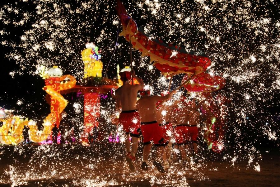 Folk artists perform a fire dragon dance under a shower of sparks from molten iron, ahead of the Chinese Lunar New Year, in Shangqiu, Henan province, China. Chinese New Year 2018,Chinese New Year 2018 animal,Chinese New Year 2018 year of dog,Chinese New Year,Chinese New Year 2018 celebrations,Chinese New Year 2018 pics,Chinese New Year 2018 images