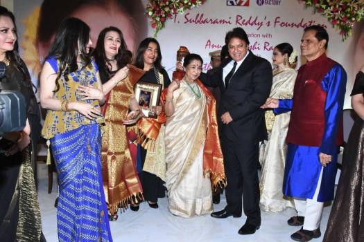 Asha Bhosle is presented with the Yash Chopra Memorial Award. The award includes Rs 10 lakh along with a 'SwarnKangan' and a trophy.