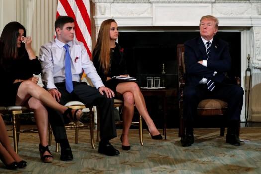 Parent Melissa Blank (L) and Marjory Stoneman Douglas High School shooting surviving students Jonathan Blank (2nd L) and Julia Cordover (2nd R) attend with other survivors and the families of victims a listening session held by President Donald Trump to discuss school safety and shootings, at the White House in Washington, February 21, 2018.