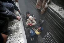 Syria Civil Defence members help an unconscious woman from a shelter in the besieged town of Douma, Eastern Ghouta, Damascus, Syria February 22, 2018.
