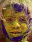 Indian child Vedika Sharma, 8, poses for a photograph covered in coloured powder after celebrating the Holi festival in Vrindavan on February 27, 2018.