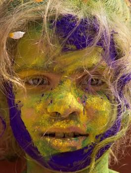 Indian child Vedika Sharma, 8, poses for a photograph covered in coloured powder after celebrating the Holi festival in Vrindavan on February 27, 2018.