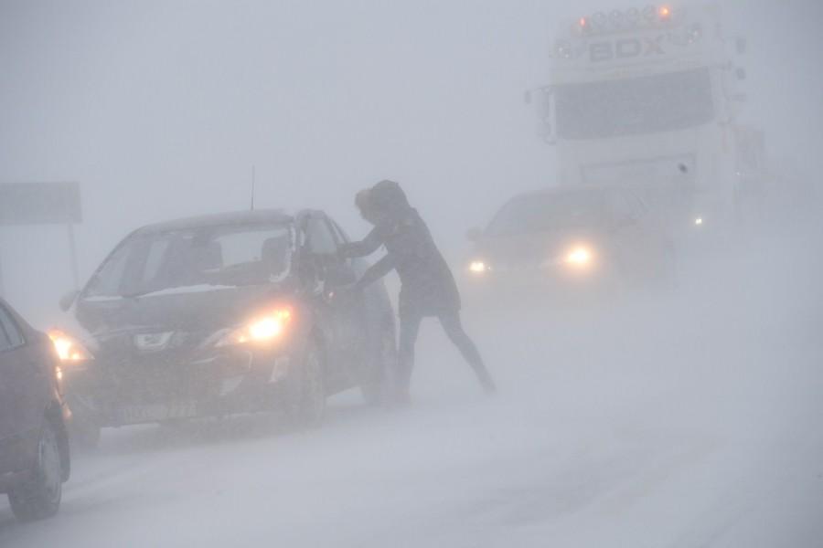 A woman seeks shelter from the blizzard in her stranded car near Sjobo, Sweden. Arctic storm,Arctic storm in Europe,Europe,Europe cold weather,Europe Arctic storm