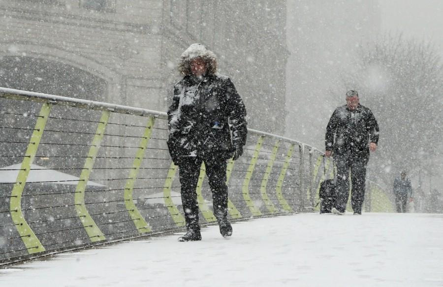 People make their way through snow in Canary Wharf, London, Britain. Arctic storm,Arctic storm in Europe,Europe,Europe cold weather,Europe Arctic storm
