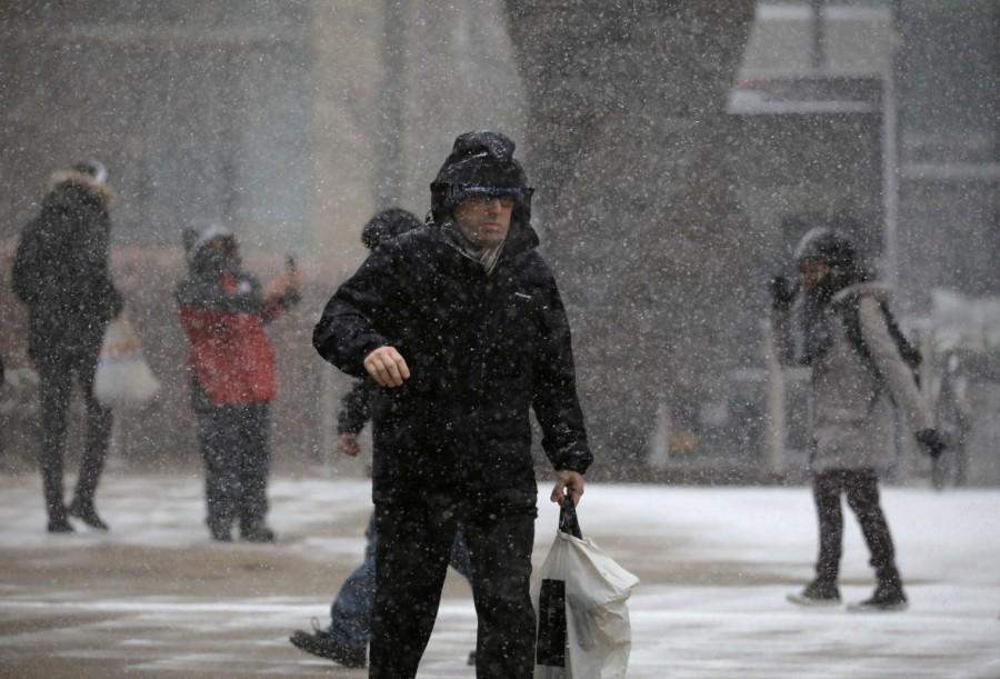 People walk during a snow storm in Canary Wharf in London, Britain. Arctic storm,Arctic storm in Europe,Europe,Europe cold weather,Europe Arctic storm