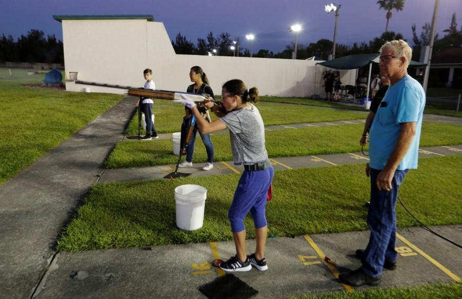 Viera Rybak, 12, shoots as instructor Steve Norris looks on. Florida youth shooting club,Florida youth,youth shooting club,Marjory Stoneman Douglas High School