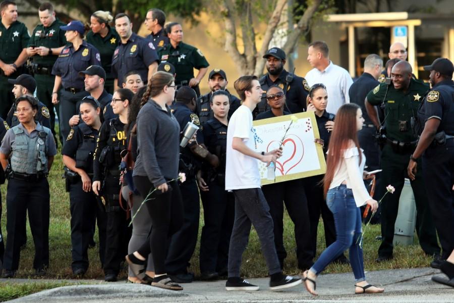 Police and law enforcement show their support as students arrive at Marjory Stoneman Douglas High School for the first time since the mass shooting in Parkland, Florida, February 28, 2018. Parkland students,Parkland students returns,mass shooting,mass school shooting,Marjory Stoneman Douglas High School