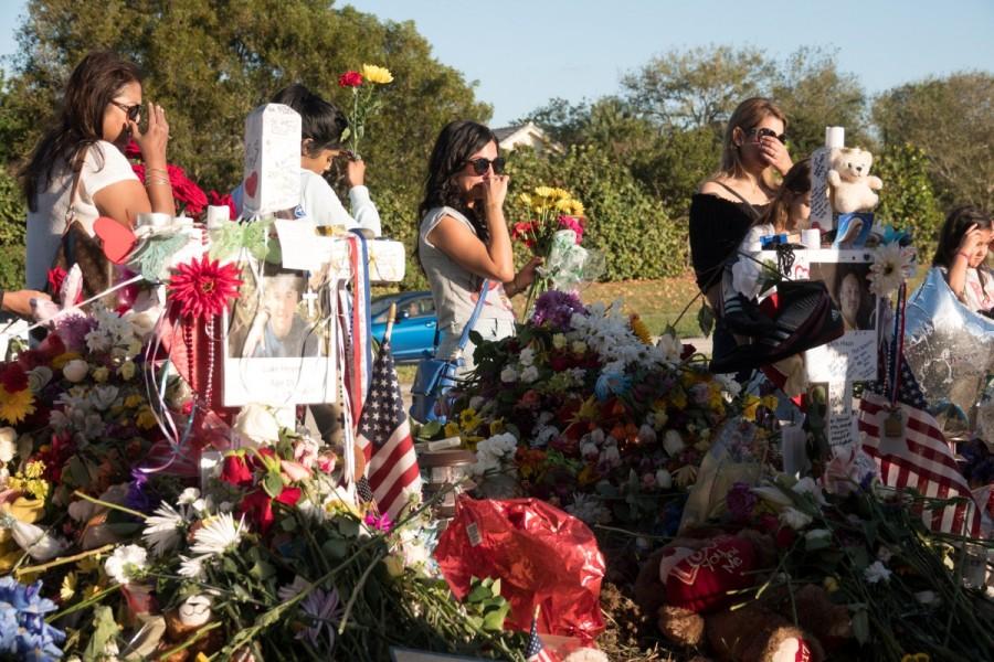 Well-wishers place mementos the day students and parents arrive for voluntary campus orientation at the Marjory Stoneman Douglas High School, for the coming Wednesday's reopening, following last week's mass shooting in Parkland, Florida,February 25, 2018. Parkland students,Parkland students returns,mass shooting,mass school shooting,Marjory Stoneman Douglas High School