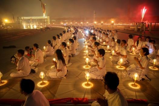 Thousands of believers join Buddhist monks praying at the Wat Phra Dhammakaya temple during a ceremony on Makha Bucha Day in Pathum Thani, Thailand.