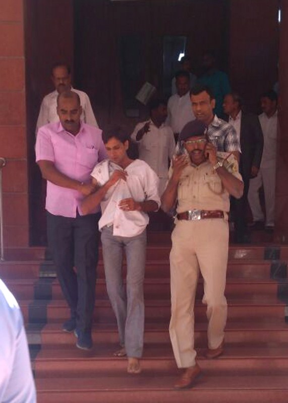 The man who stabbed Karnataka Lokayukta Justice P. Vishwanath Shetty at his office, being taken away by police in Bengaluru on March 7, 2018. Karnataka Lokayukta Justice P. Vishwanath Shetty,P. Vishwanath Shetty,Vishwanath Shetty,Vishwanath Shetty stabbed,Karnataka Lokayukta,karnataka lokayukta stabbed